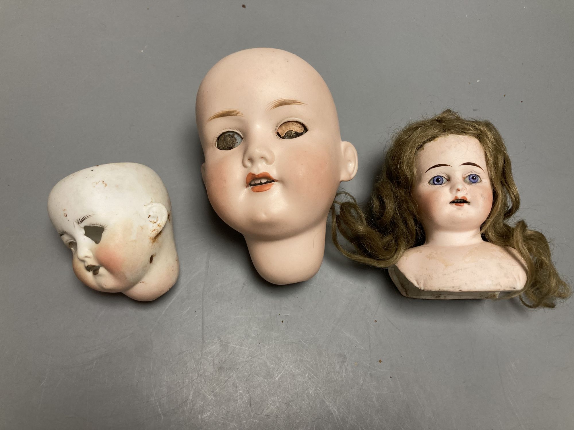 An Armand Marseille 390 bisque doll head, a Heubach Koppelsdorf bisque doll head and other